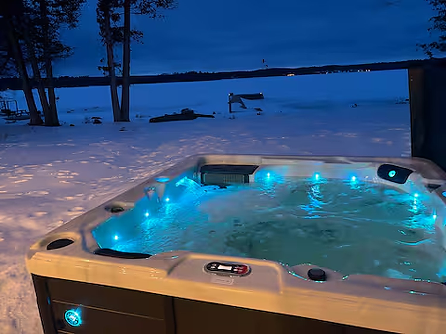 Lake-view hot tub glowing at night